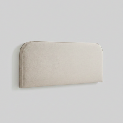 Beige upholstered headboard with a white pillow on a light gray background