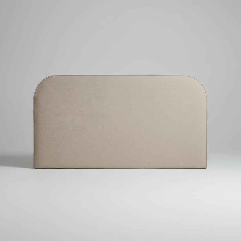 Beige upholstered headboard with a white pillow on a light gray background