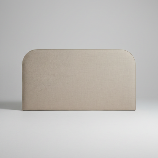Beige upholstered headboard with a white pillow on a light gray background