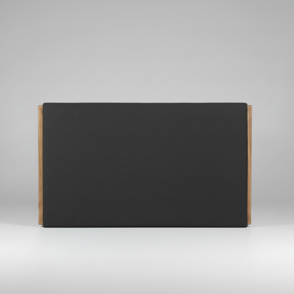 Black upholstered headboard with wooden sides on a gray background