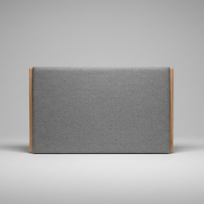 Upholstered headboard in gray fabric with wooden frame on a gray background