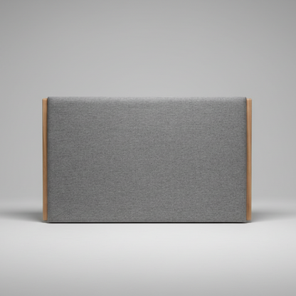Upholstered headboard in gray fabric with wooden frame on a gray background