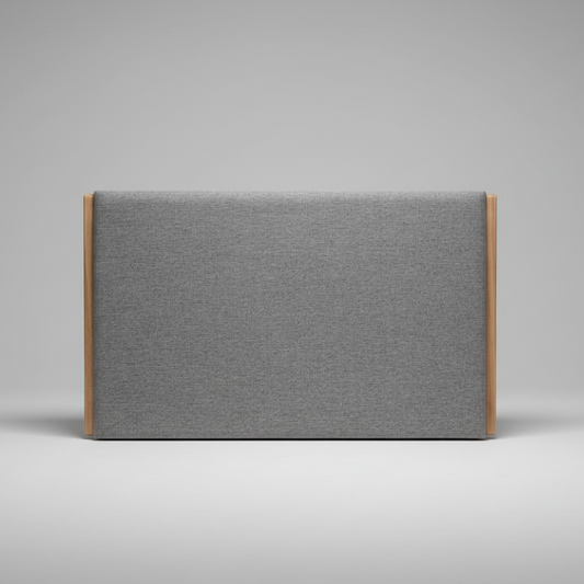 Upholstered headboard in gray fabric with wooden frame on a gray background