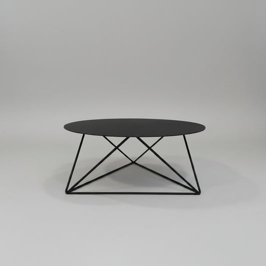 Elements Coffee Table with round black steel top and geometric frame.


