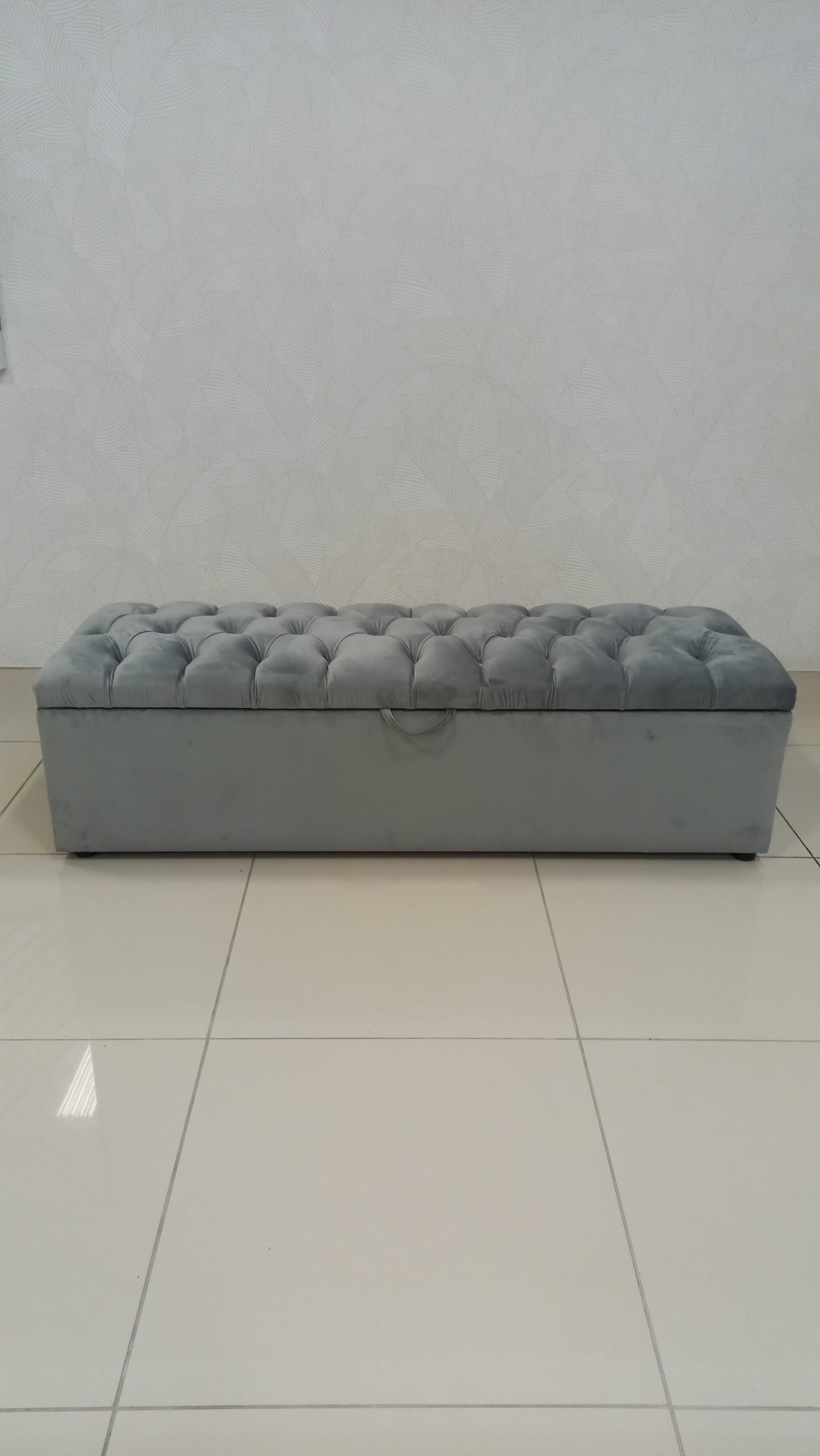 Deep Button Storage Ottoman with tufted lid and hidden storage.