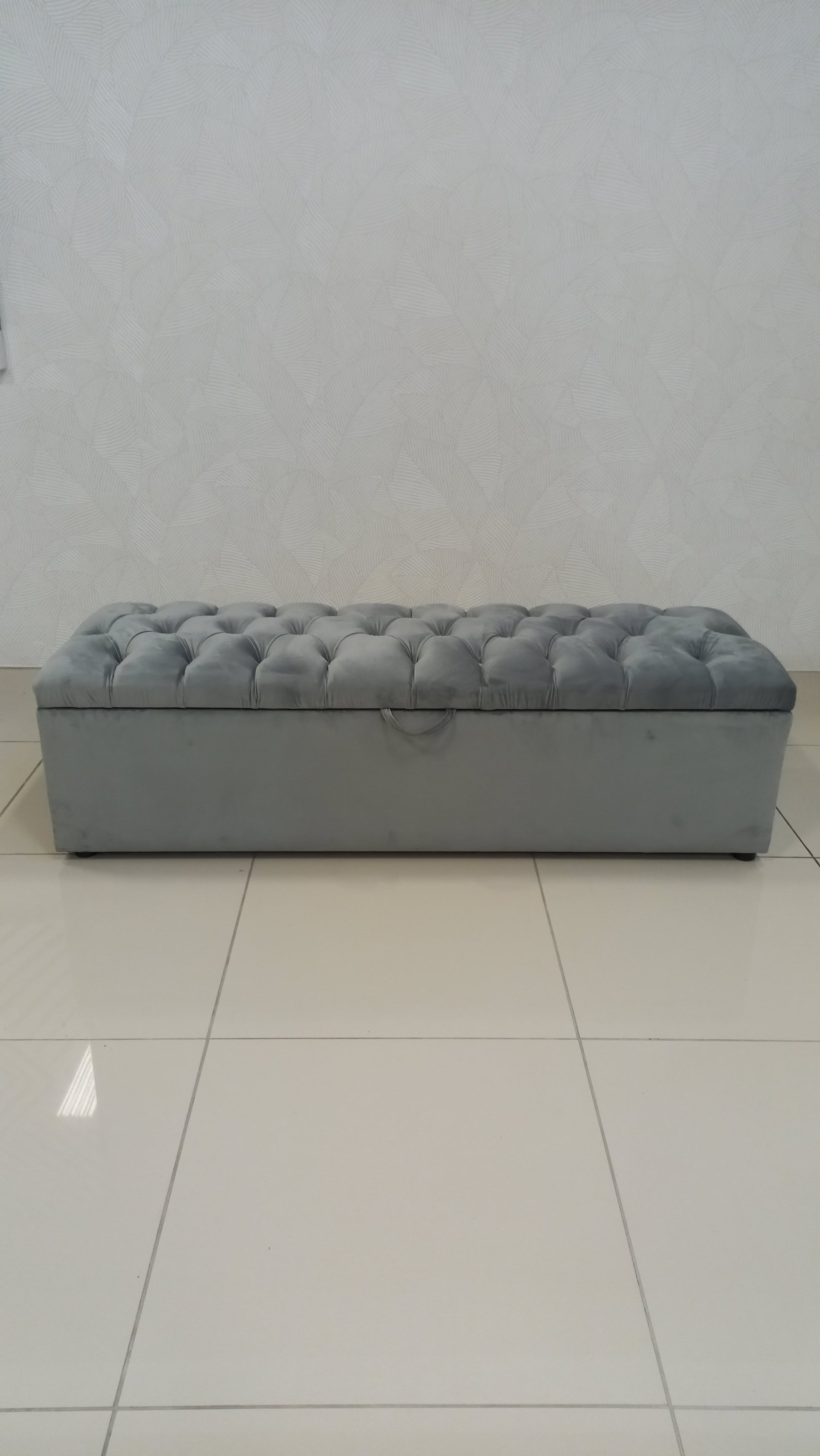 Deep Button Storage Ottoman with tufted lid and hidden storage.