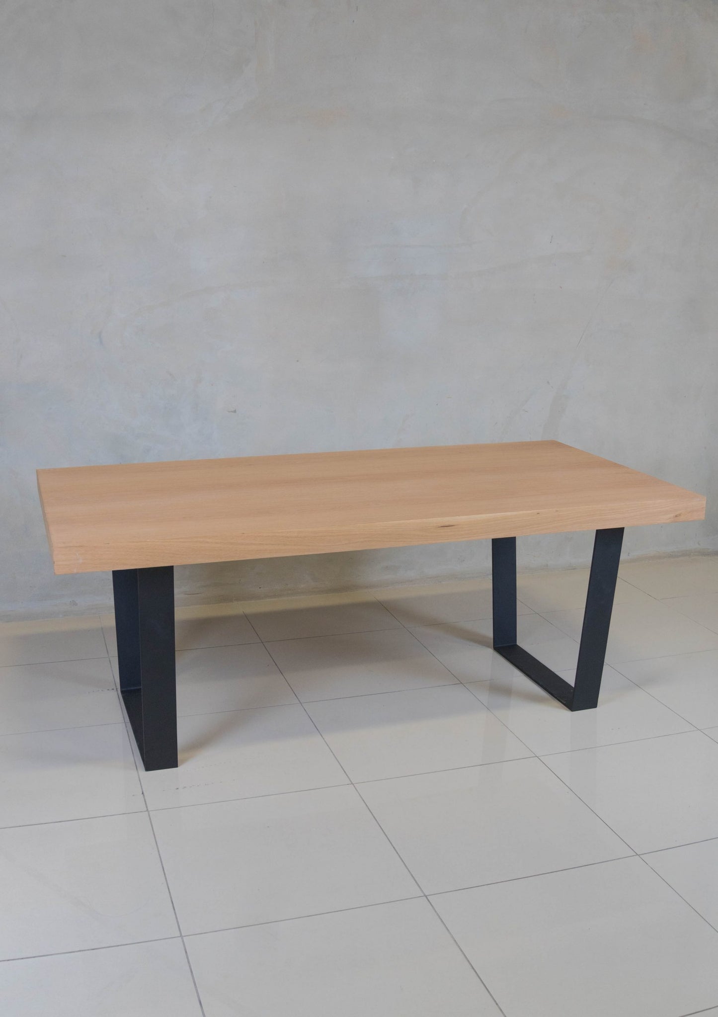 Holtz Dining Table with oak veneer top and modern black epoxy-coated steel base.
