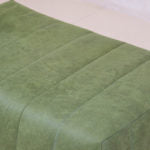 Trout Block Ottoman with fluted sides and upholstered top.