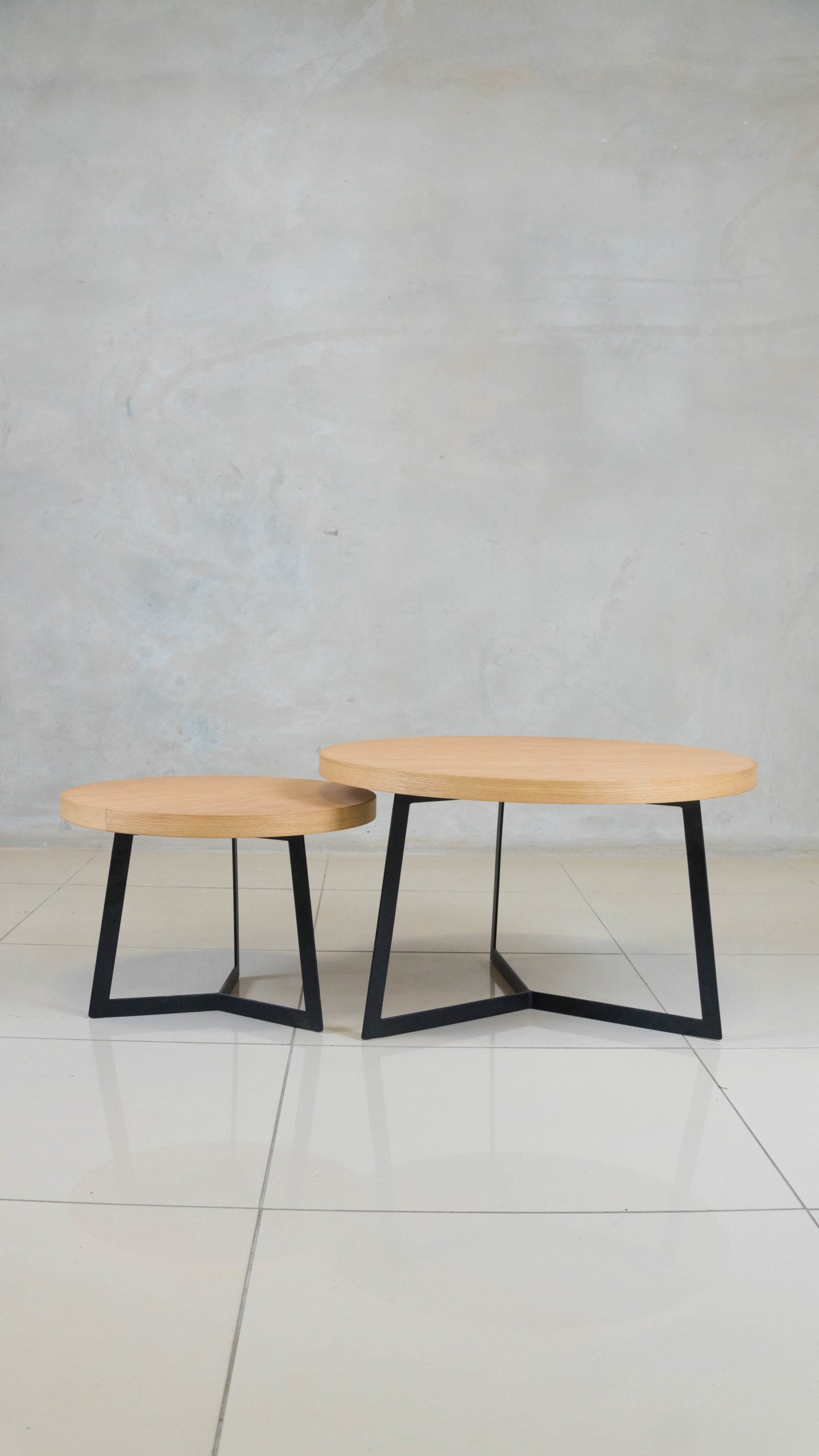 Eclipse nesting coffee table set with oak tops and black steel frames.