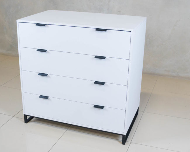 Sleek Chest of Drawers in white melamine with black handles.