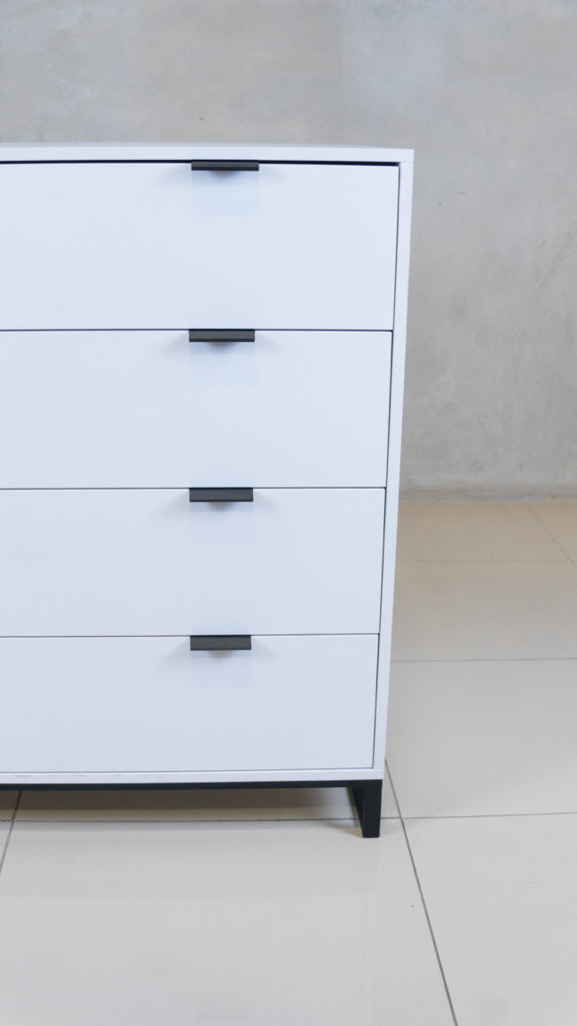Sleek Chest of Drawers in white melamine with black handles.