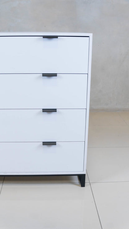 Sleek Chest of Drawers in white melamine with black handles.