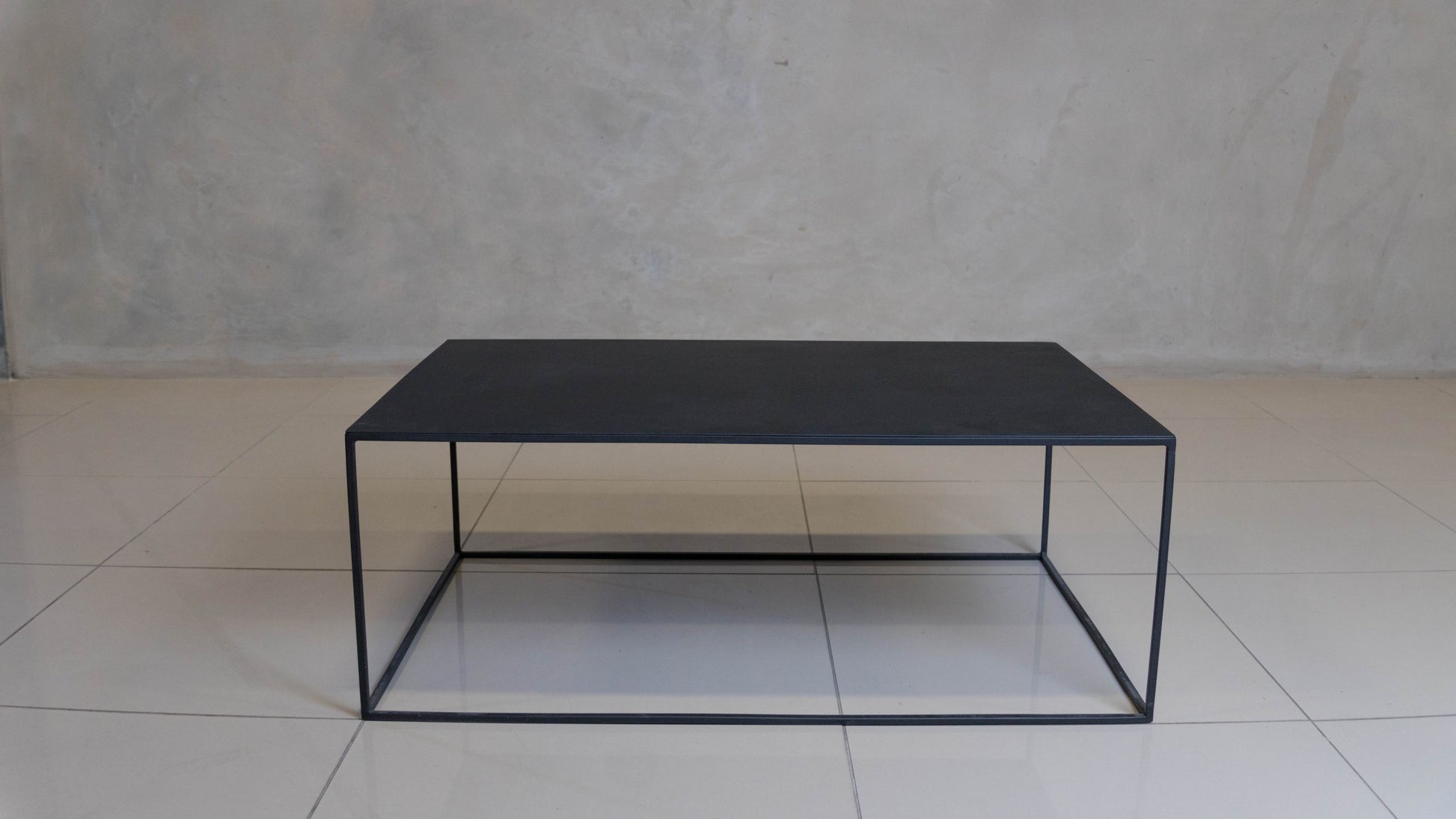 Corretto Steel Table featuring a minimalist design and epoxy-coated steel construction.