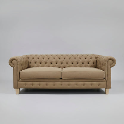 Beige tufted sofa on a gray background