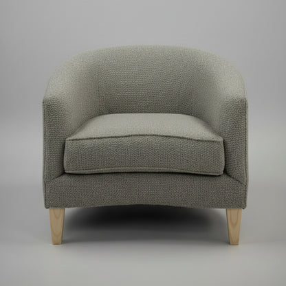 Ovo Armchair with round tub shape and oak feet.